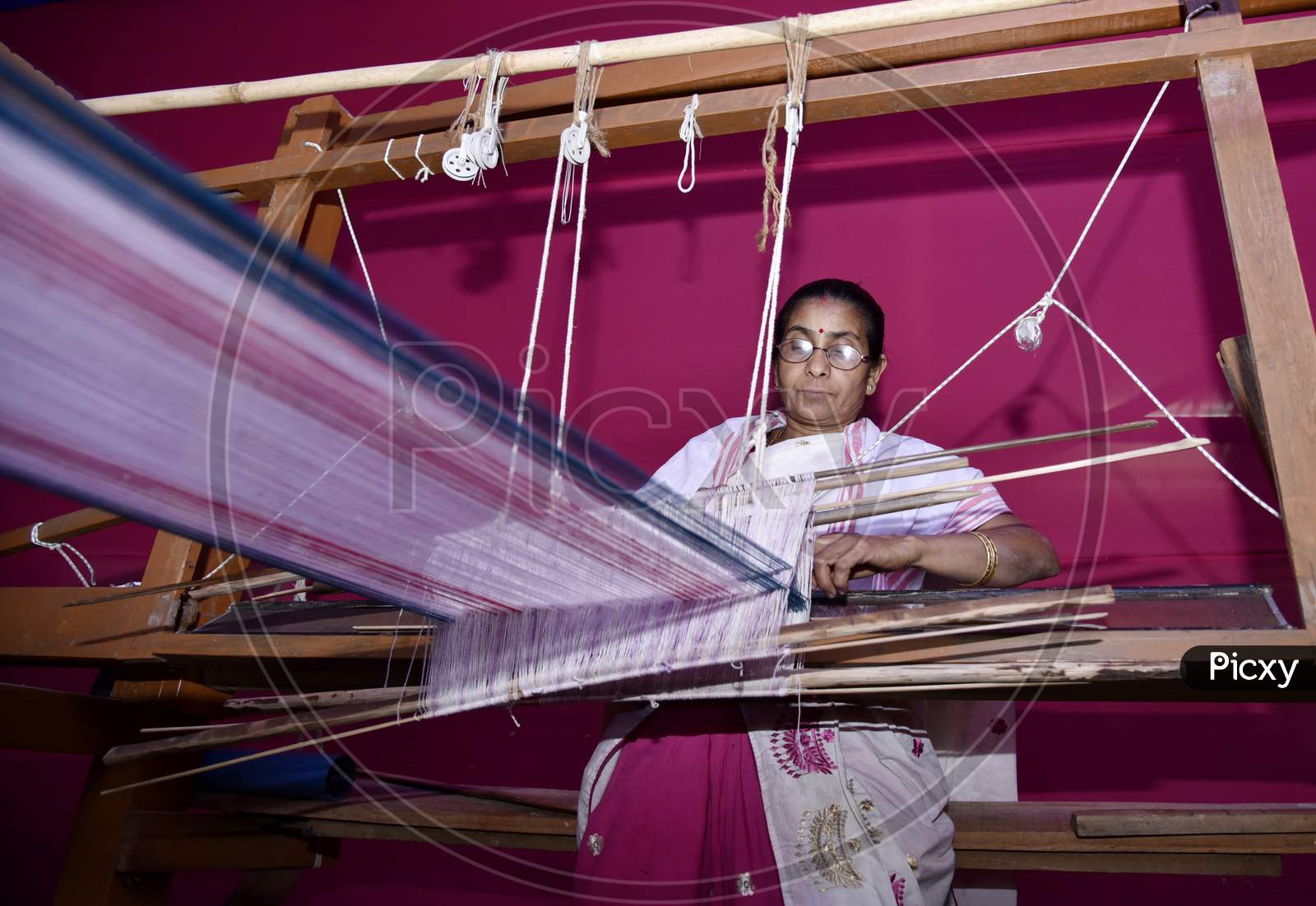 Women Weaving Assamese Traditional Gamosa Agead Of Rongali Bihu In Assam.