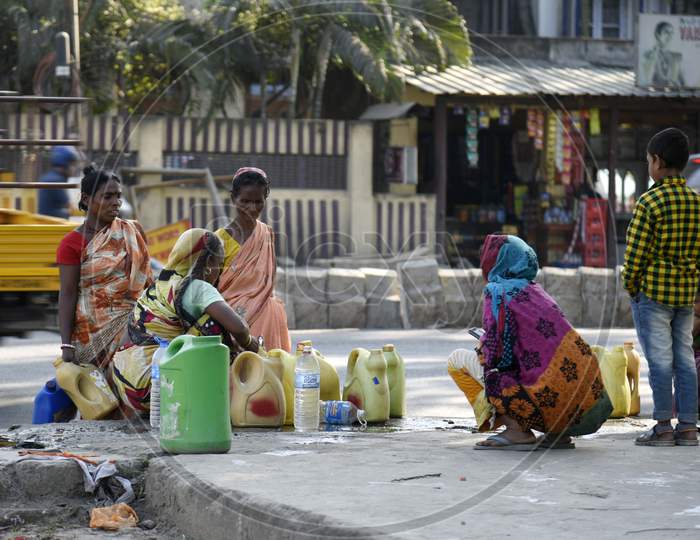 Women Catches Water From A Leakage Pipe