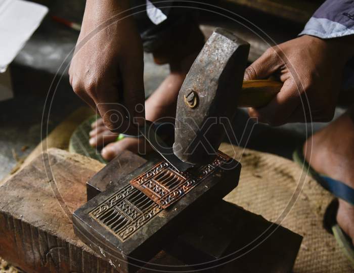 Worker Making Silver Jewellery In A Traditional Method In A Assamese Jewellery Manufacturing Unit.