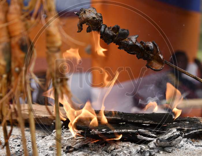 Assamese Street Food Pork Belly Being Barbecued on Fire In  Food Stall In Guwahati , Assam