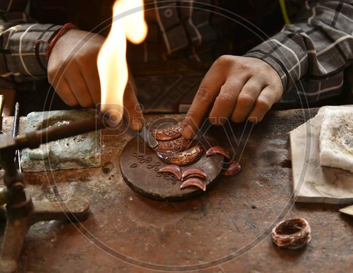 Worker Making Silver Jewellery In A Traditional Method In A Assamese Jewellery Manufacturing Unit In Nagaon, Assam