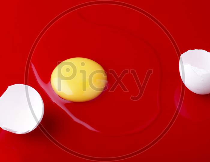 Egg Break On Red Background