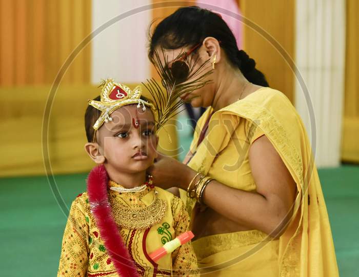 Mother Prepares Her Child For Vedic Dress Completion In The Occasion Of  Shree Krishna Janmastami, The Birthday Of Lord Krishna, In Guwahati, Assam, India
