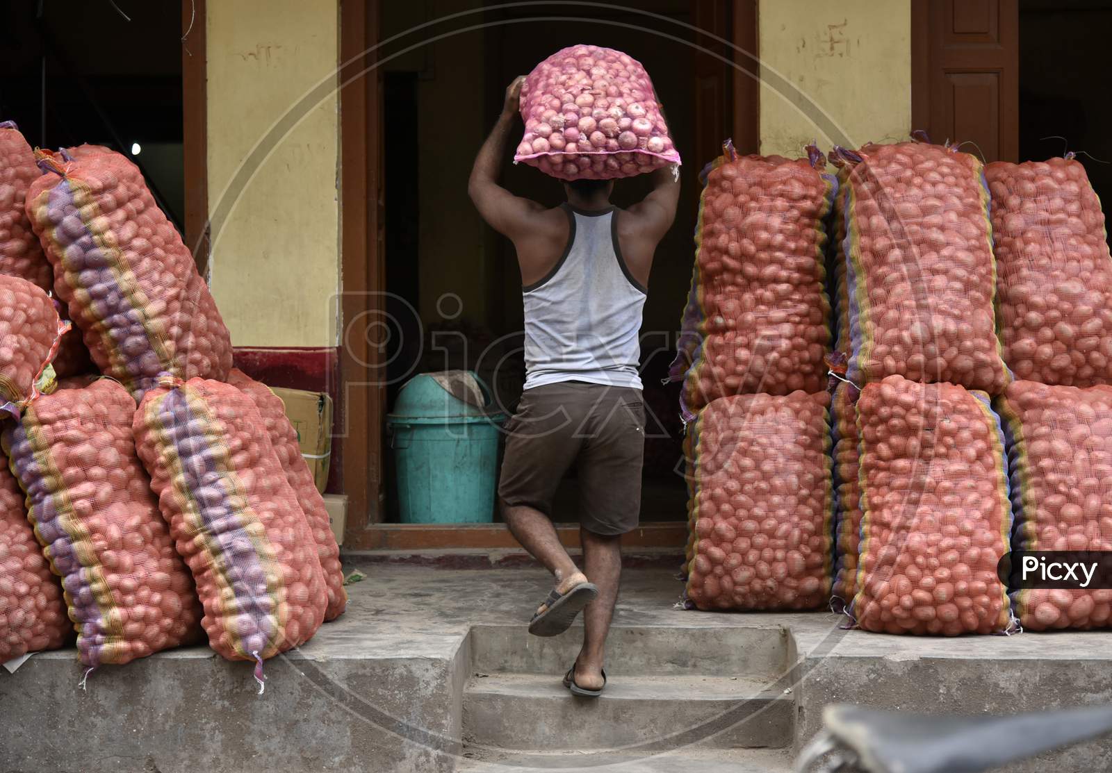 Daily Worker Carrying Onions in an Market