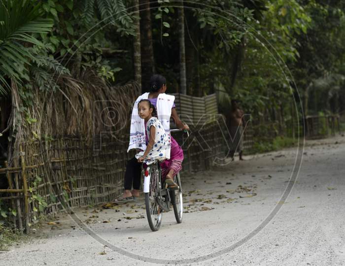 Daily Life. Baksa, Assam, India. October 22, 2019. Woman Returning Her Child From School By Bicycle At Gati Village, In Baksa District Of Assam, Some 140 Km From Guwahati, On October 22, 2019. Photo: David Talukdar