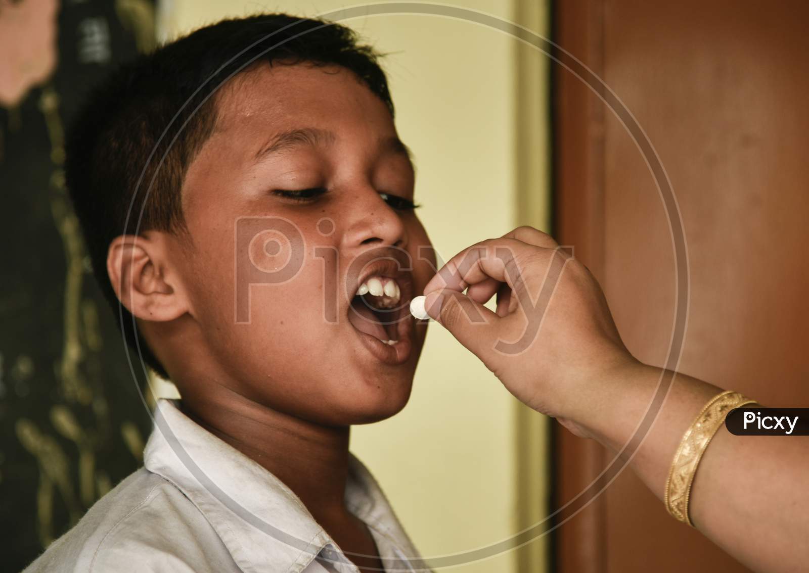 School Student Recieves Albendazole Tablet As Part Of India'S National Deworming Programme At A Primary School In Guwahati, Assam, India