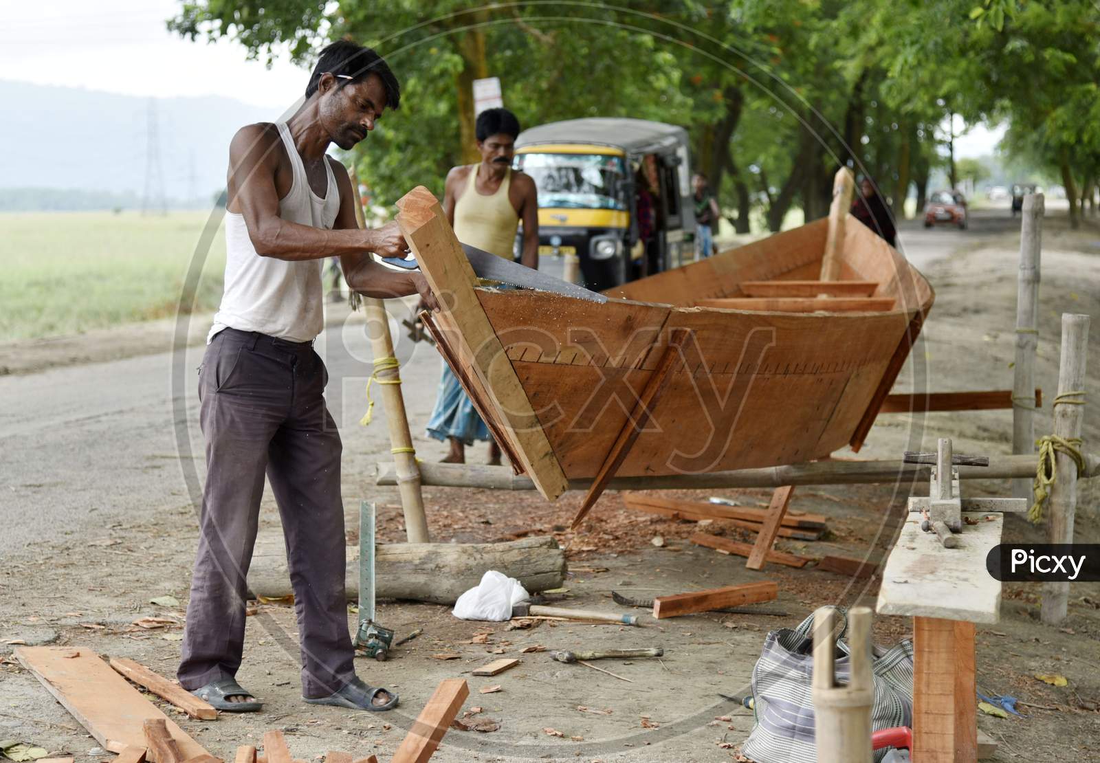 Carpenter Making A Boat To Sell, At A Flood Affected Village In Morigaon District Of Assam, India