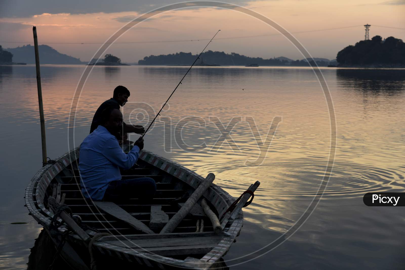 Indian Men Fishing In The Brahmaputra River At Sunset, In Guwahati, Assam