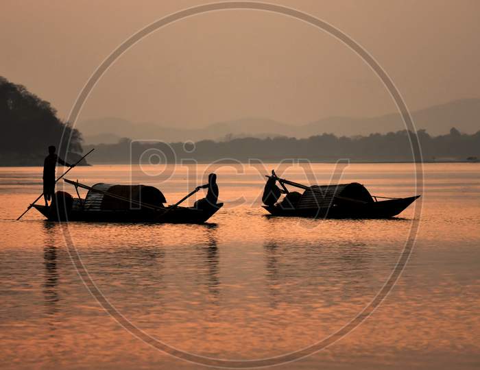 Silhouette Of Fisherman Boats On River Bramhaputra  In Guwahati , Assam