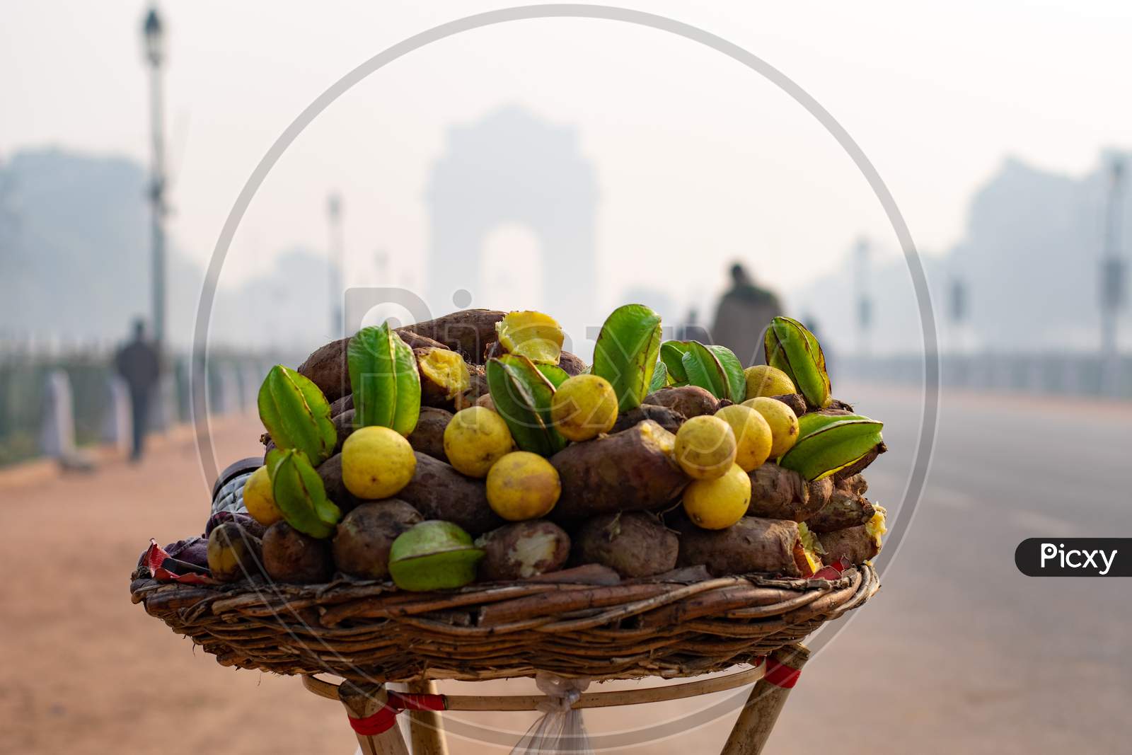 Sweet potatoes and star fruits in front of India Gate in Delhi
