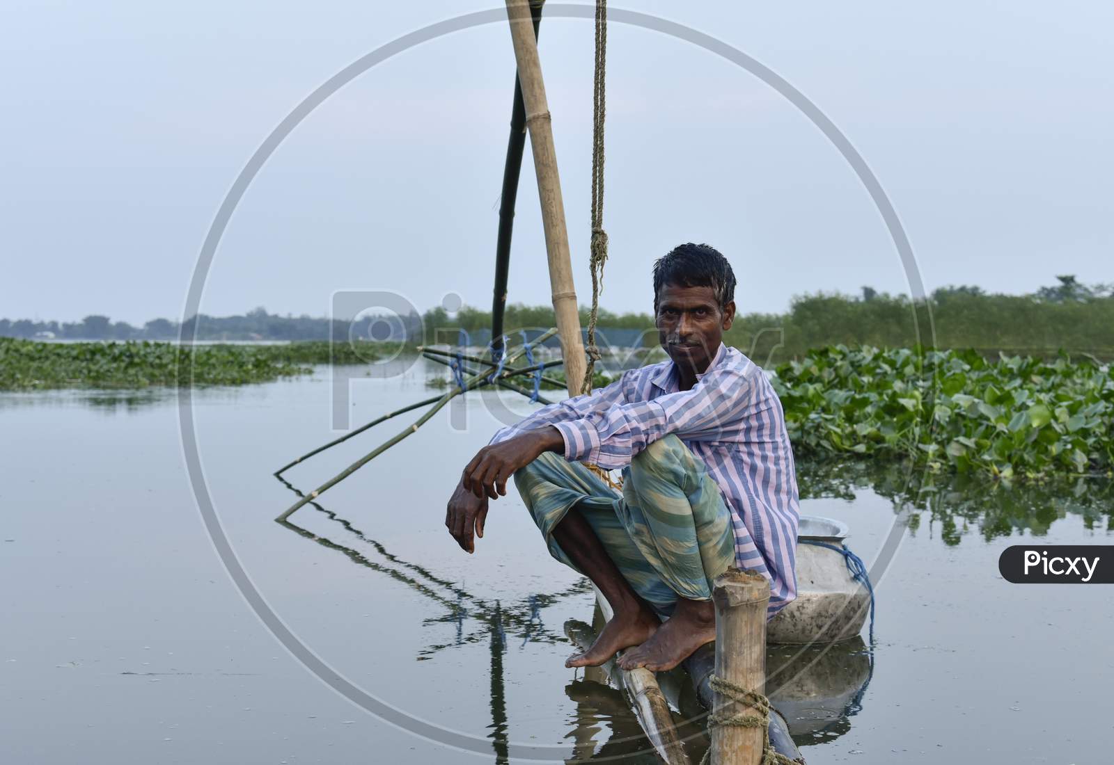 Image of A Fisherman Fishing On River Bramhaputra in Guwahati