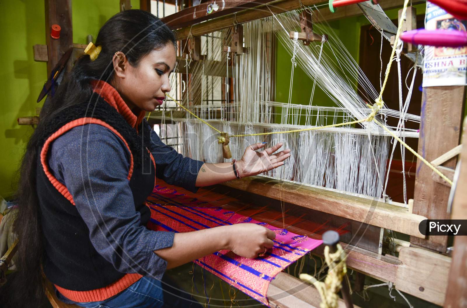 Women Weaving Assamese Silk Costumes In A Traditional Method In A Manufacturing Unit At Nagaon, Assam.