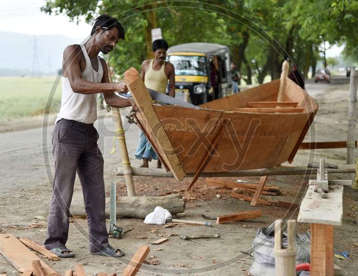 Carpenter Making A Boat To Sell, At A Flood Affected Village In Morigaon District Of Assam, India