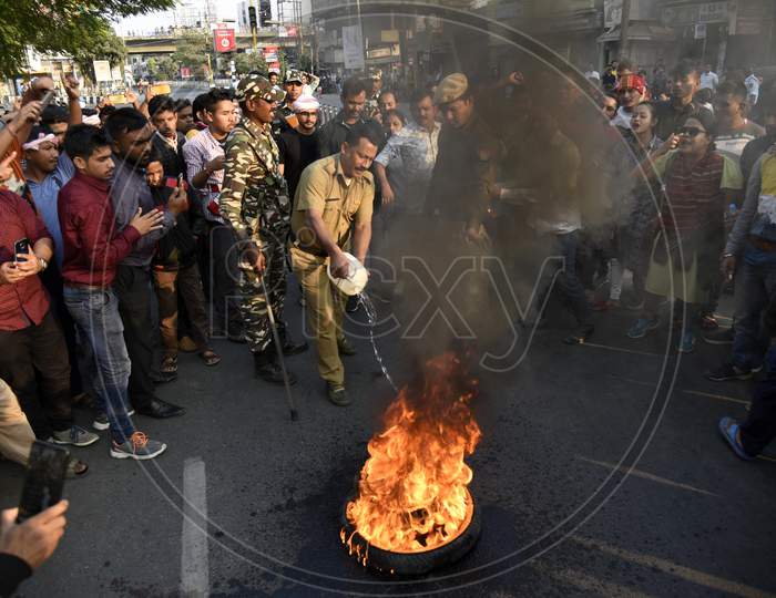 Police Or Security Personnel Stopping The Fire Set By Protesters  in Guwahati City