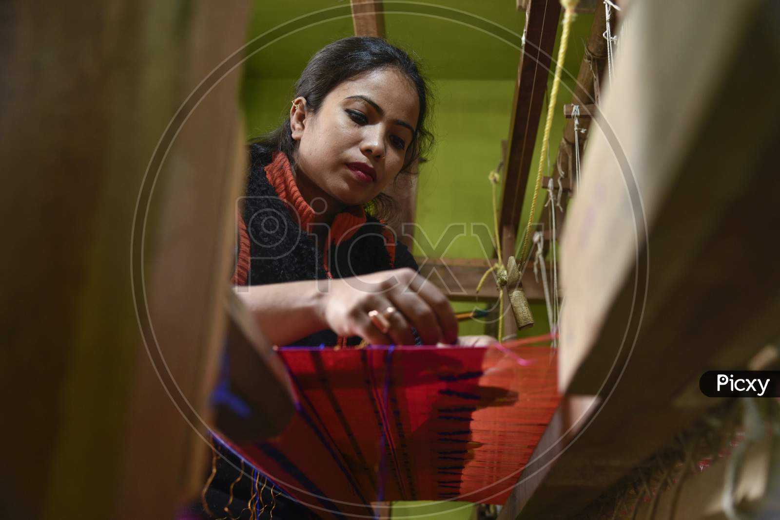 Women Weaving Assamese Silk Costumes In A Traditional Method In A Manufacturing Unit At Nagaon, Assam.