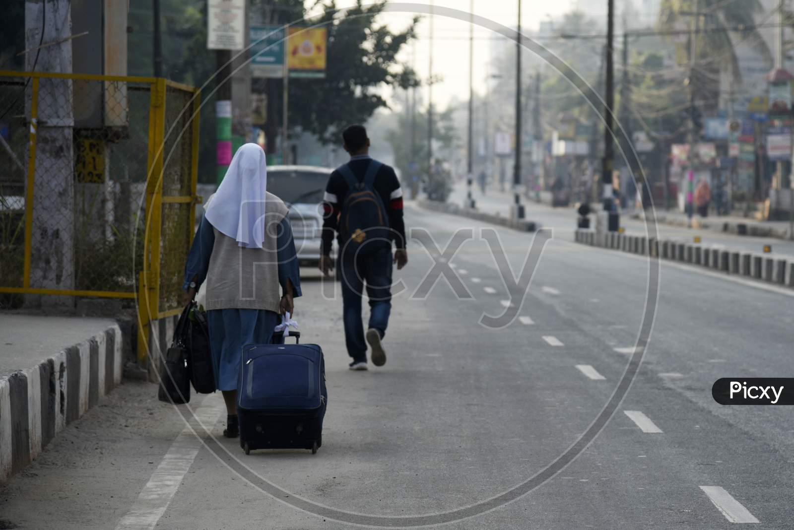 People Walking With Luggage In The Street, During A Strike Called By All Assam Students’ Union (Aasu) And The North East Students’ Organisation (Neso) In Protest Against The Citizenship Amendment Bill, In Guwahati