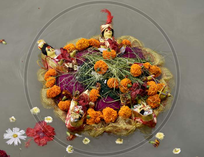 Hindu Tradition Of Leaving Flowers And  Hindu God Idols in Water
