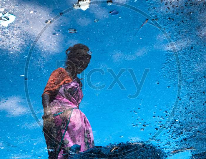 Reflection Of an Old Woman On Water Surface