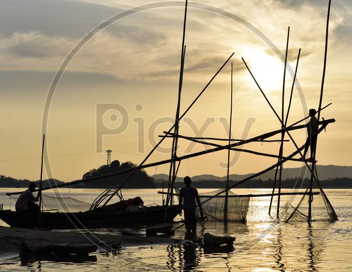 Silhouette Of Fisherman With China Fishing Nets At Bramhaputra River Bank In Guwahati