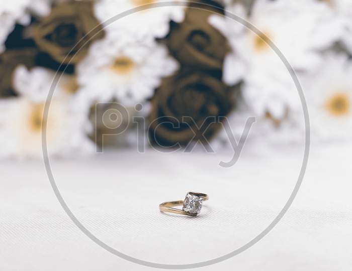 Diamond Ring With Flower in Background