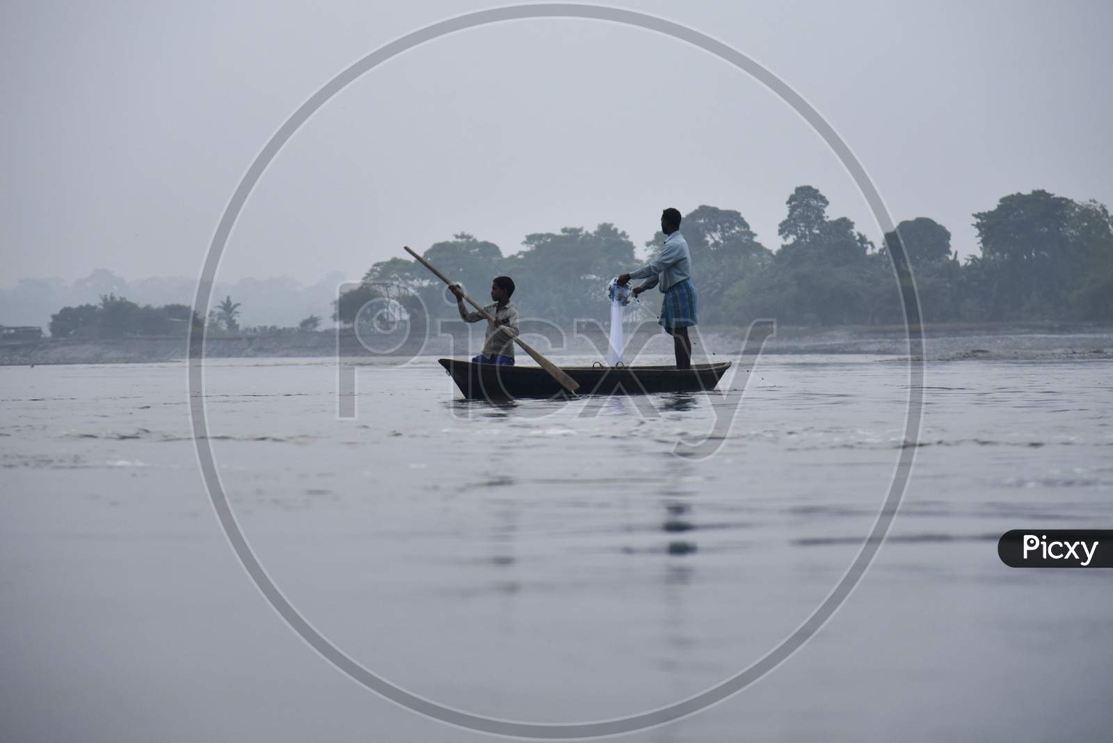 Fishermen Lay Their Fishing Net In The Manas River In Baksa District Of Assam