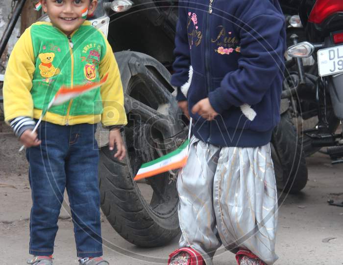 Indian Young Children With Indian National Flags  on Delhi Streets