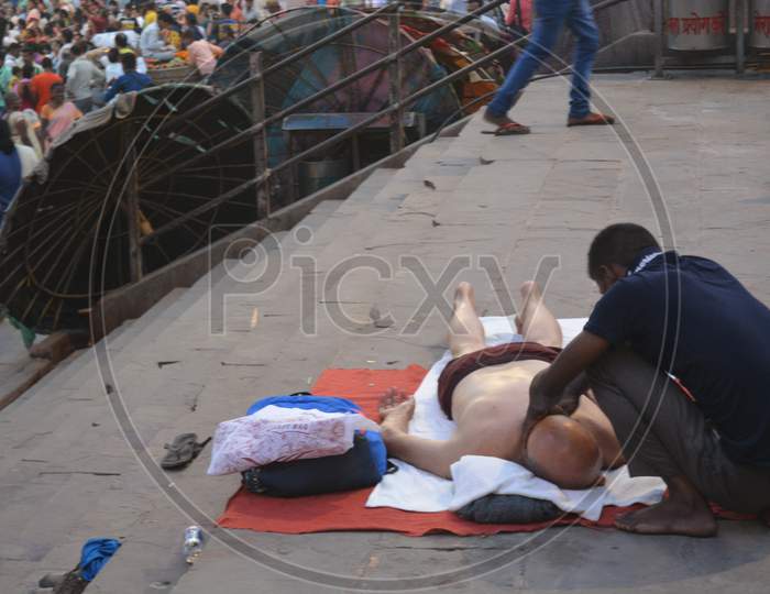 Man Performing Massage To an Tourist  At  Varanasi Ghats
