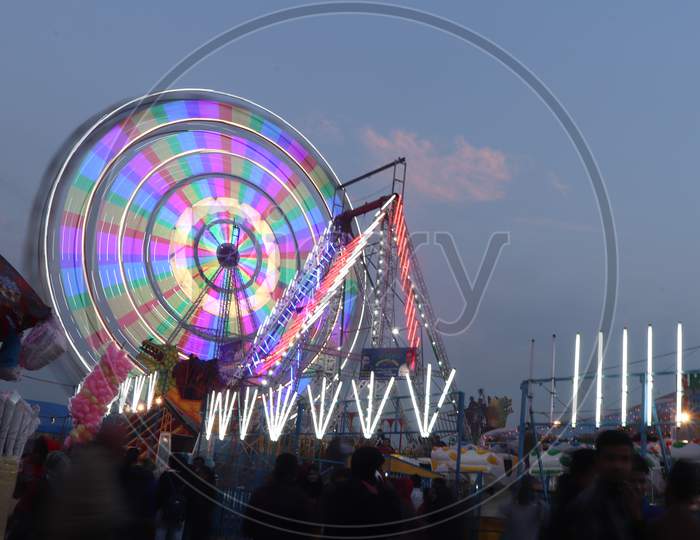 Amusement Rides In a Fair With Giant Wheel