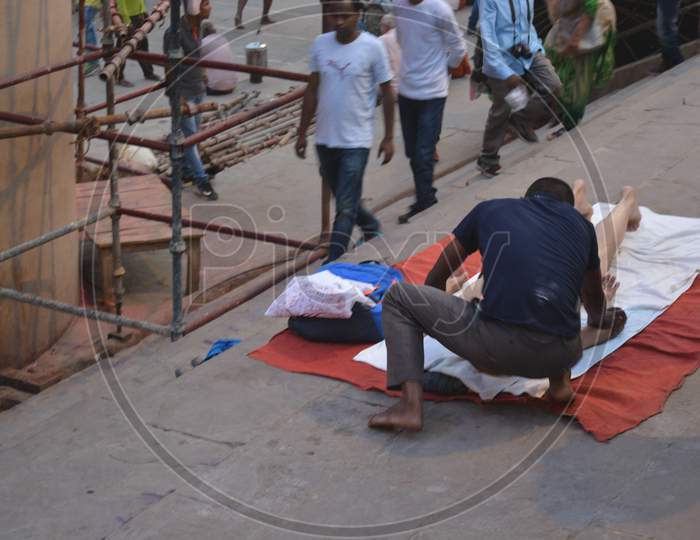 Man Performing Massage To an Tourist  At  Varanasi Ghats