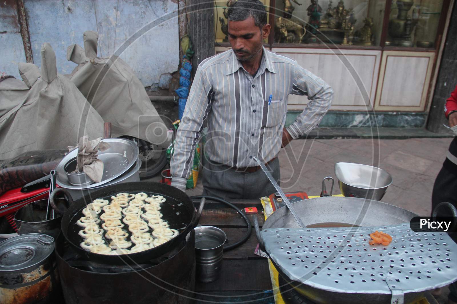 Indian Street Food Vendor Making Jilebi At a Stall