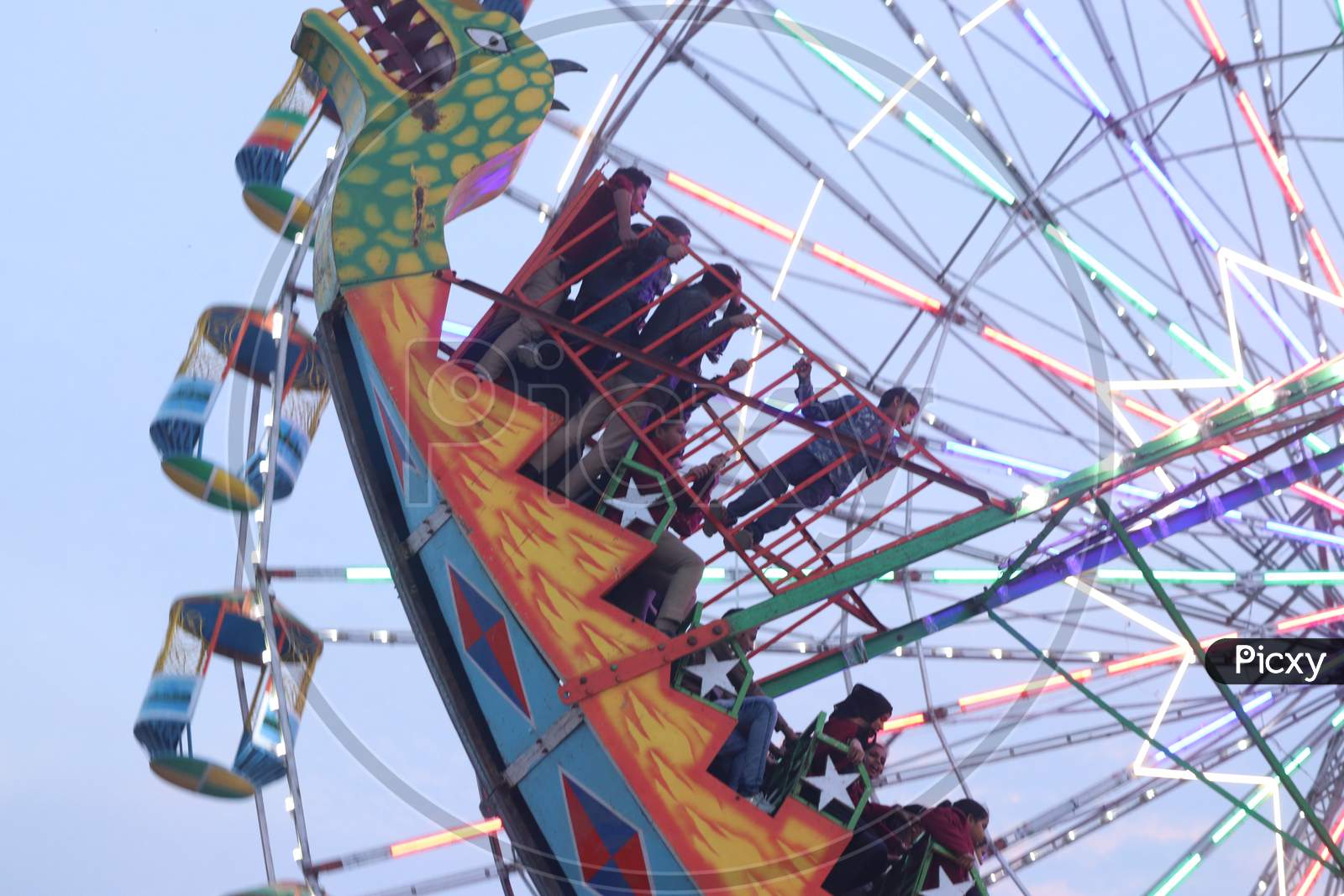 Amusement Rides in an Fair With Children Enjoying Rides