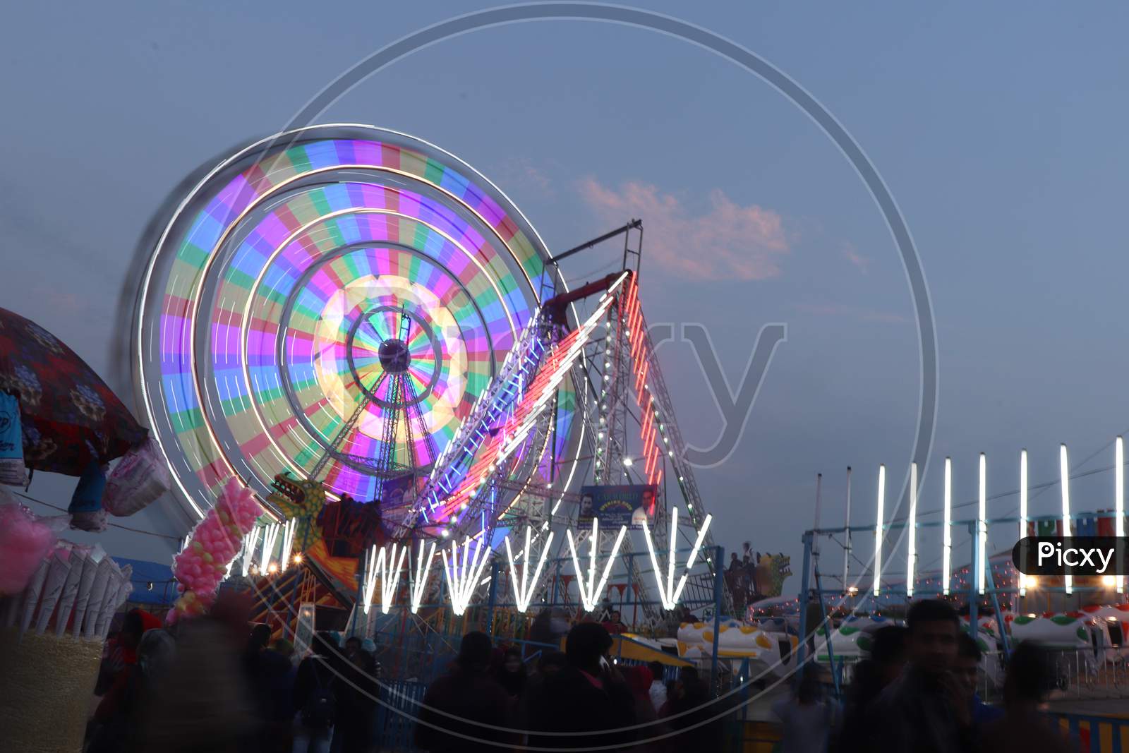 Amusement Rides In a Fair With Giant Wheel