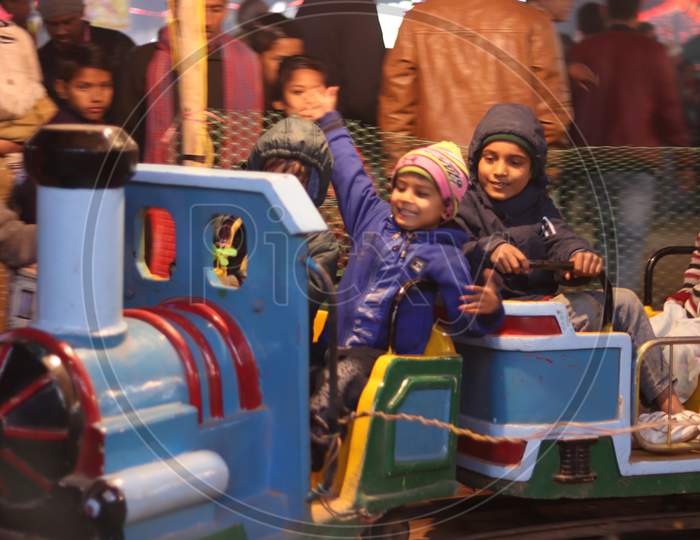 Children Enjoying Amusement Rides in an Fair