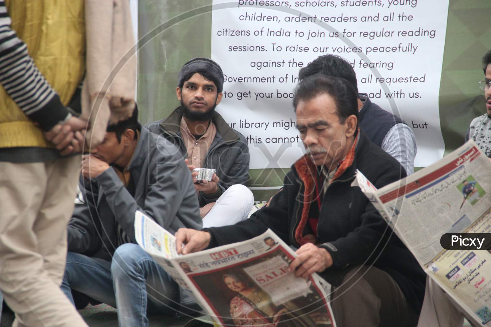 Protesters Reading Newspapers  During Protest At Delhi