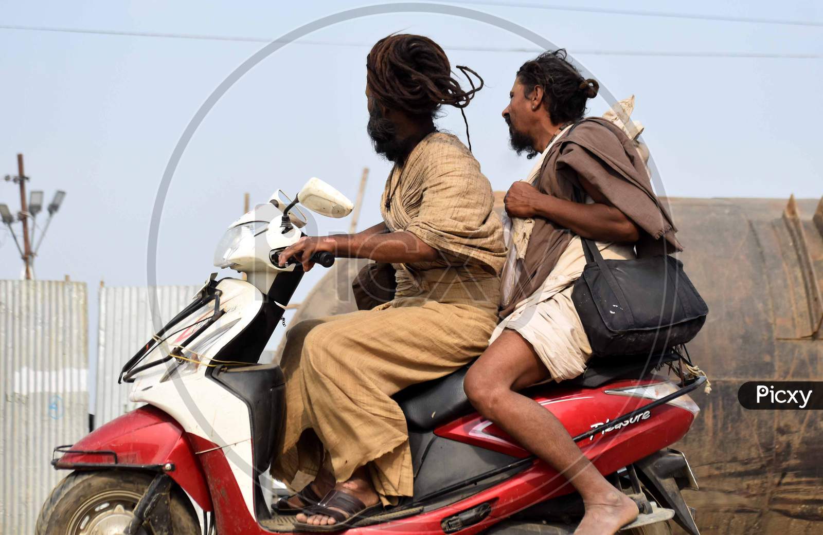 Indian Priests Or Sadhu Driving a Scooty
