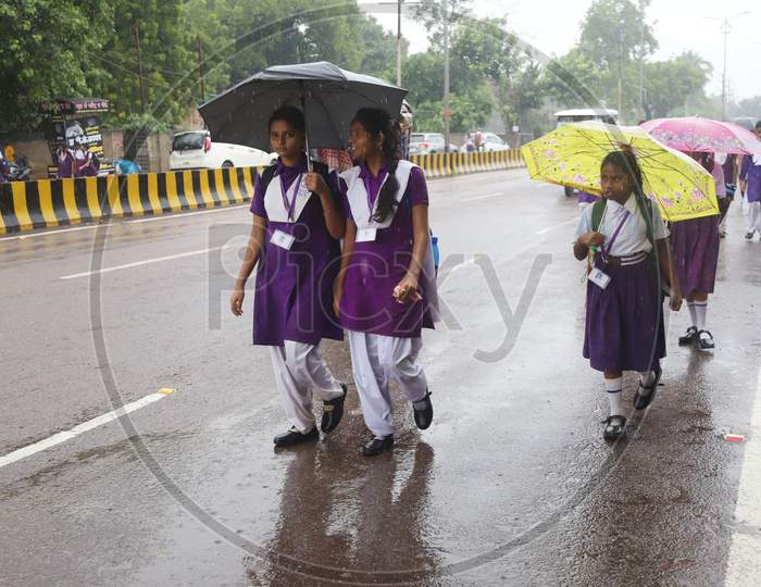 School Girls Walk On The Road During Heavy Rain In Prayahraj
