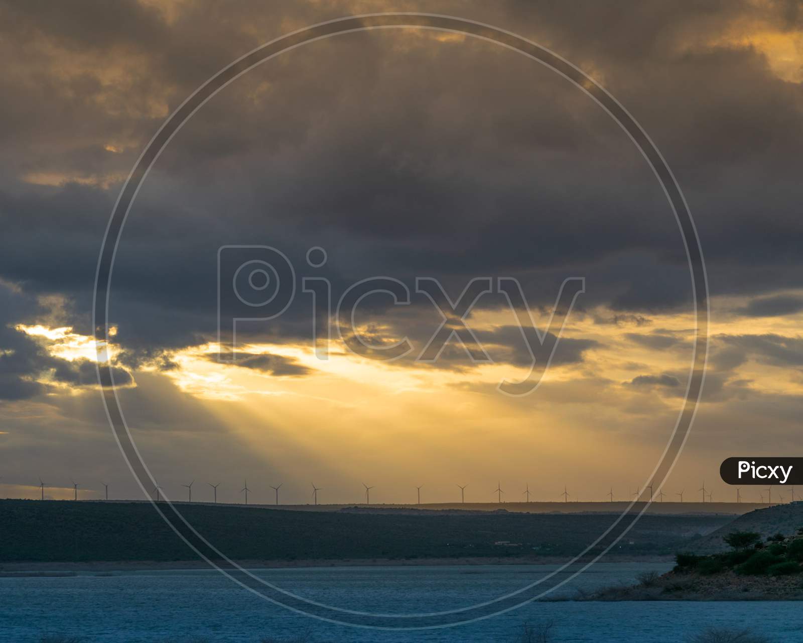 Sunset over Windmills At a Tropical Beach Land