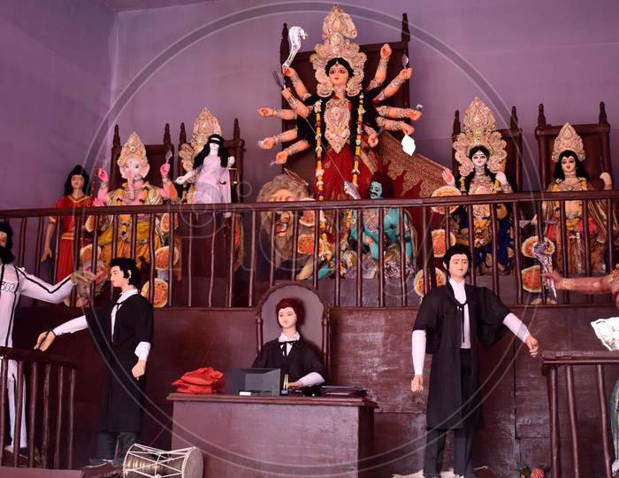 A Puja Pandal Where All The Five Deities Are Seen Sitting On The Dais Of A Courtroom, With Maa Durga As The Judge And Demon Mahishsasur Is Seen In Custody In Prayagraj