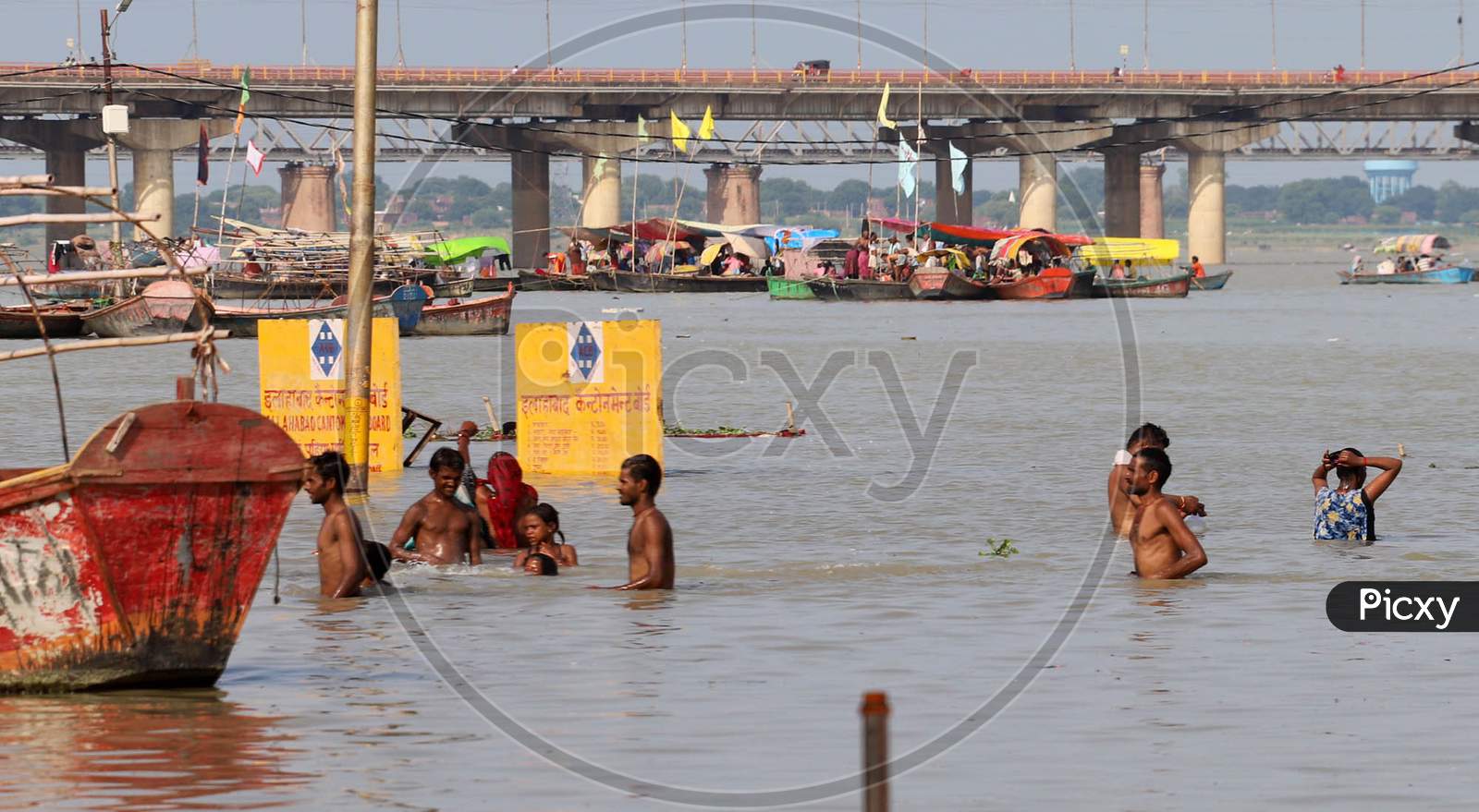 Hindu Devotees Takes Holy Dip In The Flooded Water Of Sangam, Confluence Of Three Rivers, The Ganga, The Yamuna And Mythical Saraswati In Prayagraj,