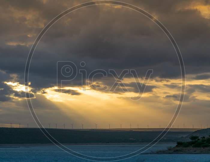Sunset over Windmills At a Tropical Beach Land