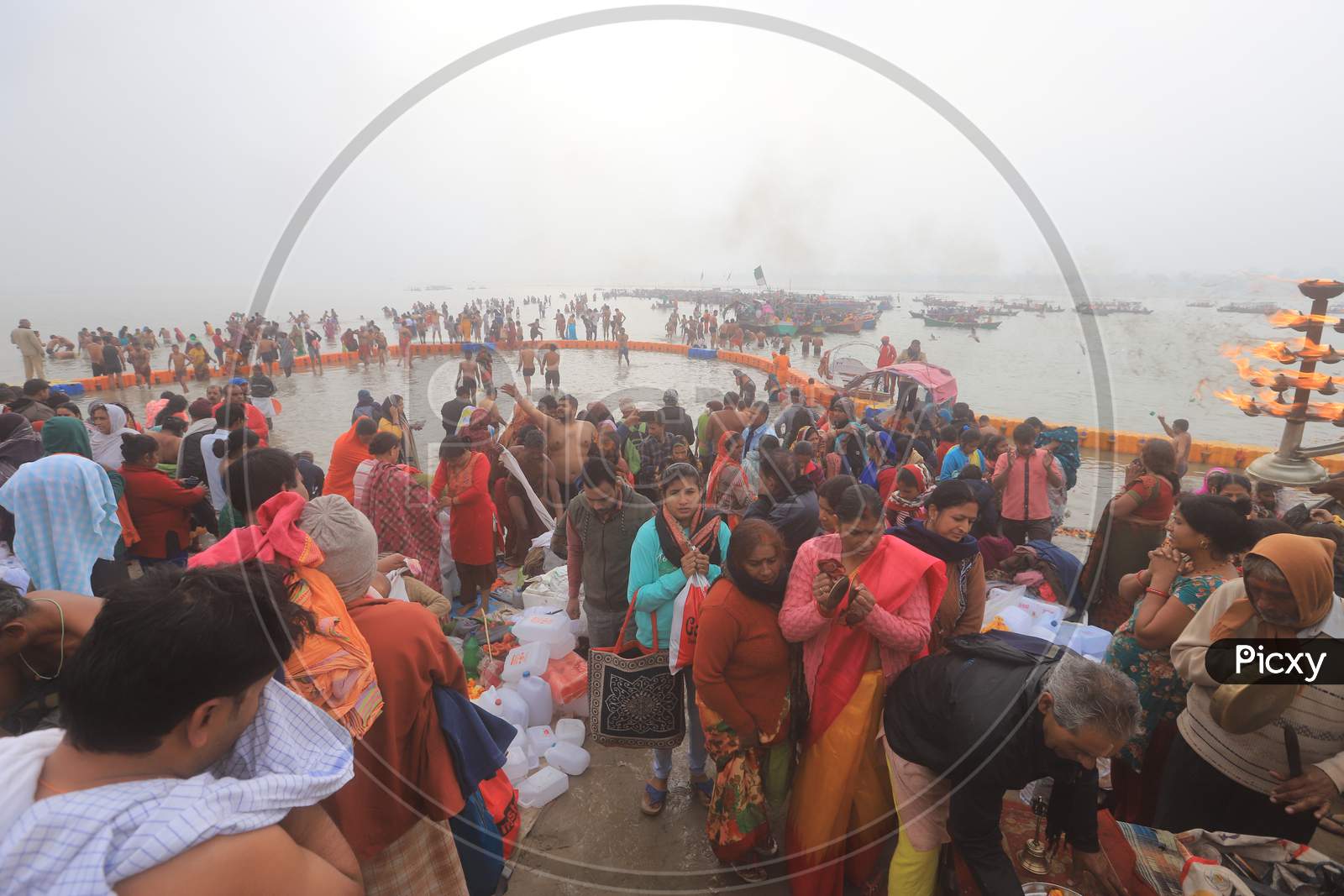 Hindu Devotees Offering Prayers To Lord Bade Hanuman Infront Of Submerged Temple In The Flood Water Of River Ganga In Prayagraj