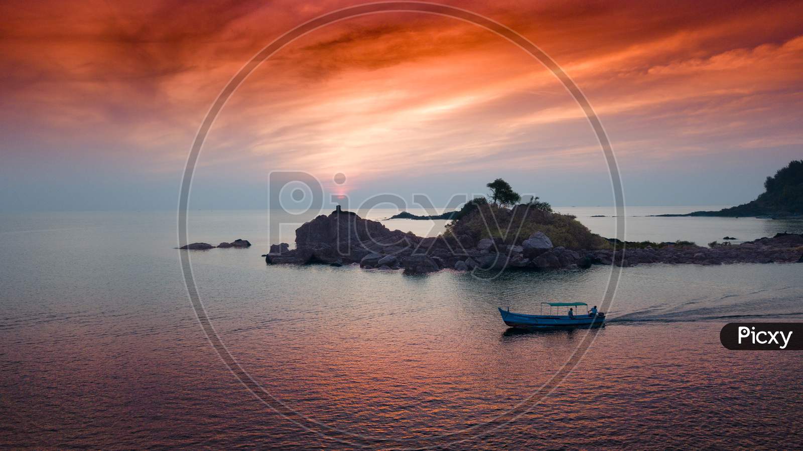 Aerial View Of A Boat On Sea With Sunset Sky In Background
