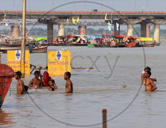 Hindu Devotees Takes Holy Dip In The Flooded Water Of Sangam, Confluence Of Three Rivers, The Ganga, The Yamuna And Mythical Saraswati In Prayagraj,