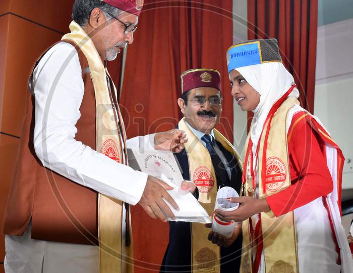 A Girl Receiving Graduation Certificate At a College Graduation Day