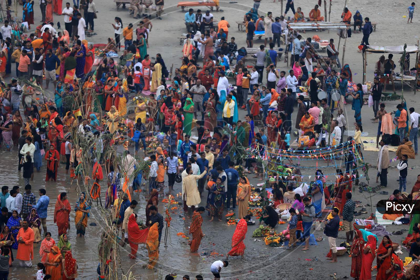 Hindu Women Worship The Sun God In The Waters Of The Ganga River During The Religious Festival Of Chhath Puja In Prayagraj