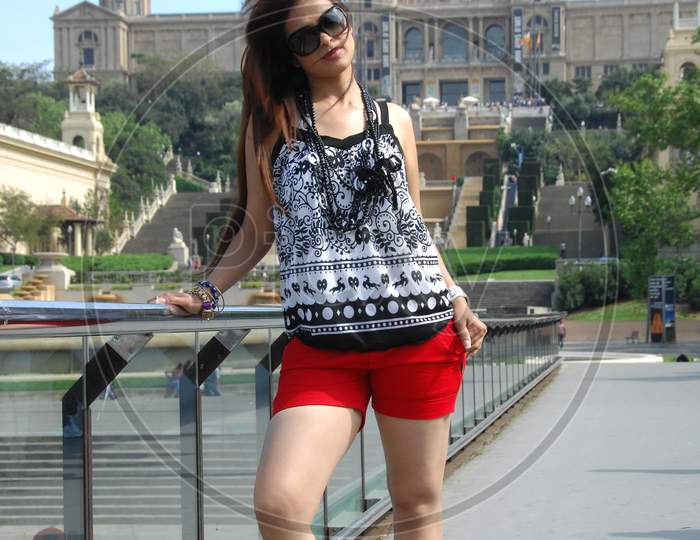 Indian Girl posing wearing red shorts and sunglasses
