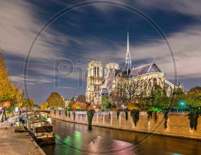 View Of Notre-Dame De Paris From The Banks Of The Seine At Night