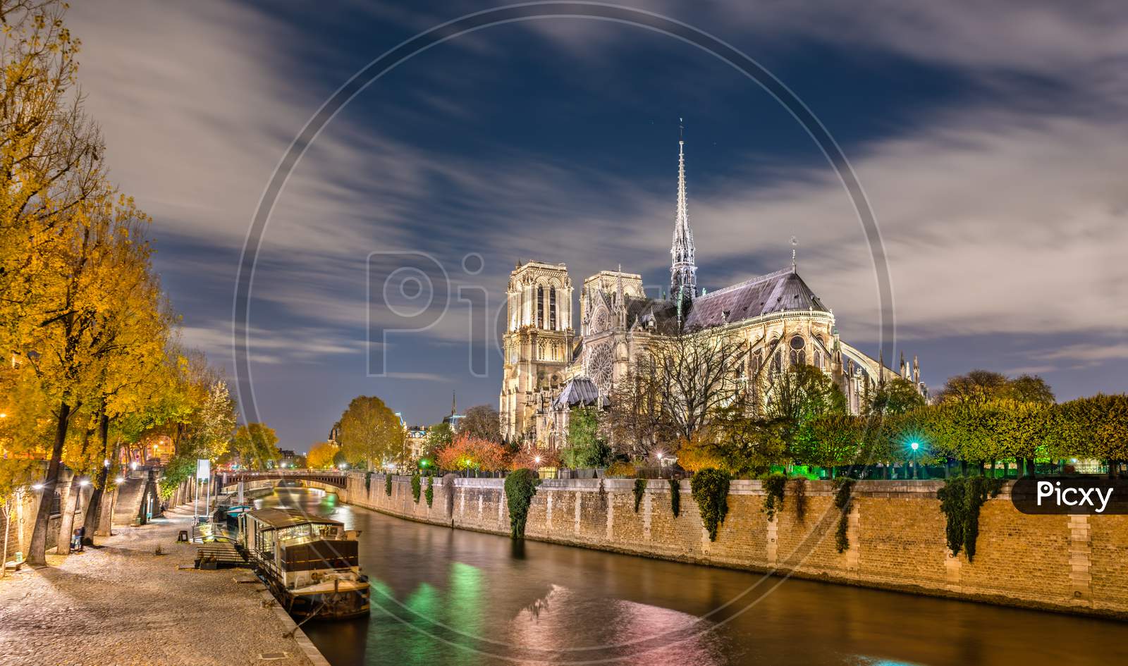 View Of Notre-Dame De Paris From The Banks Of The Seine At Night