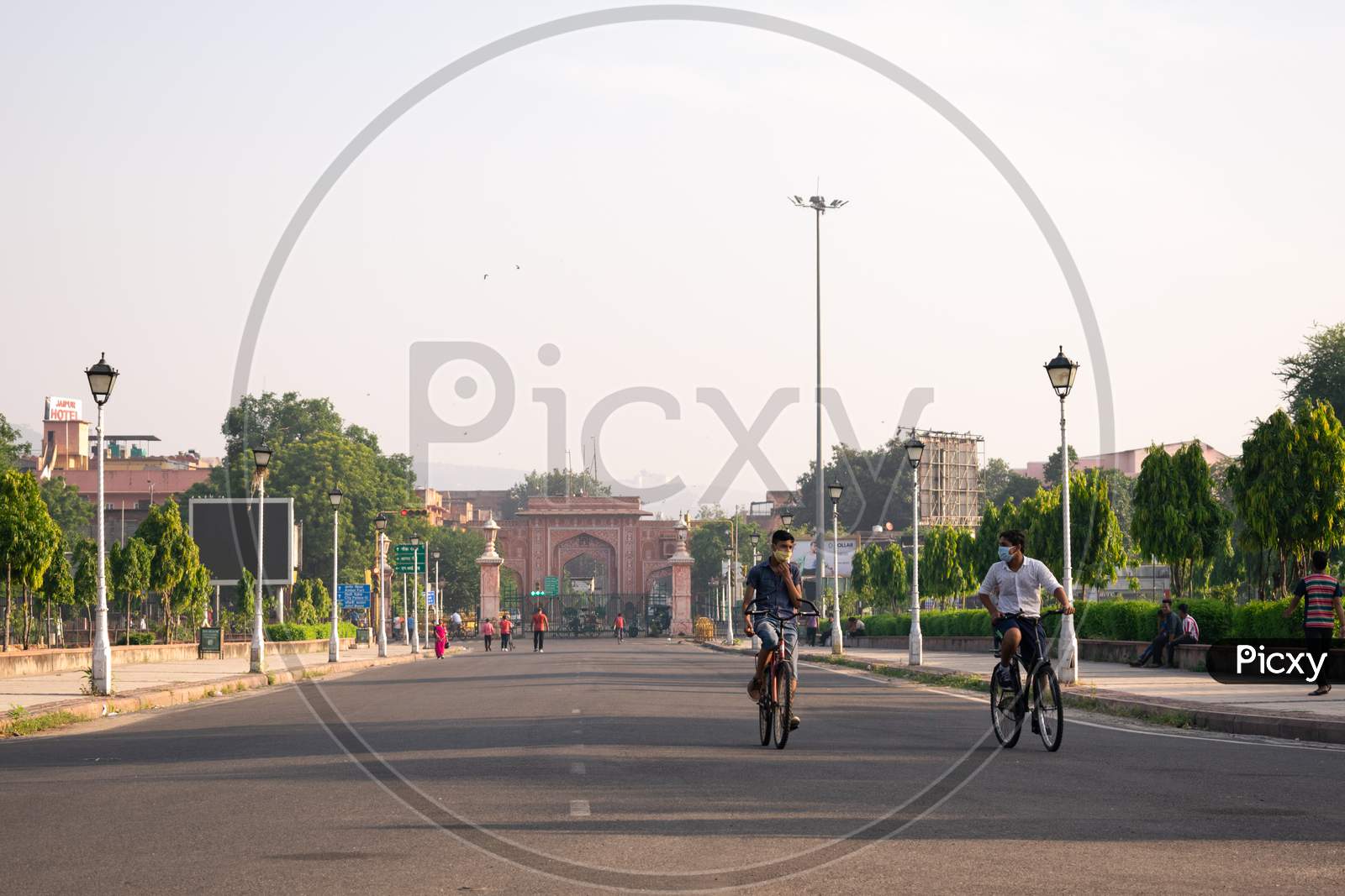 Boys, wearing mask, cycling in the morning