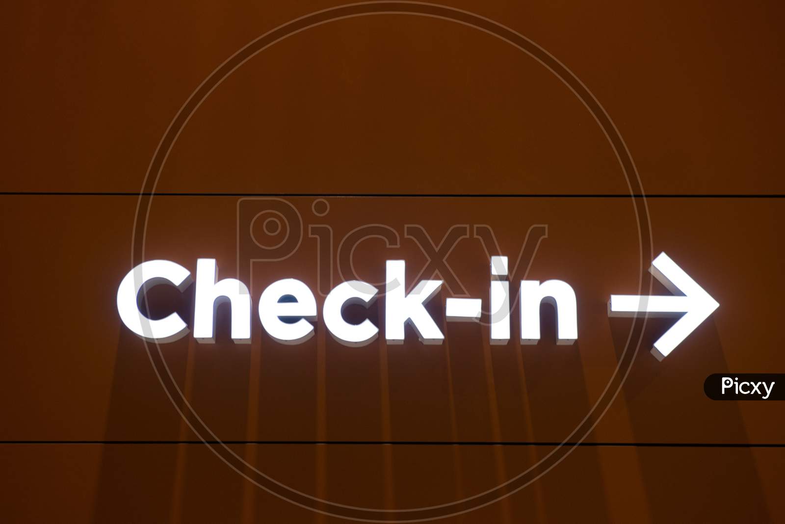 Airport Check-In Illuminated Sign With A Arrow Pointing To Right In A Wall.